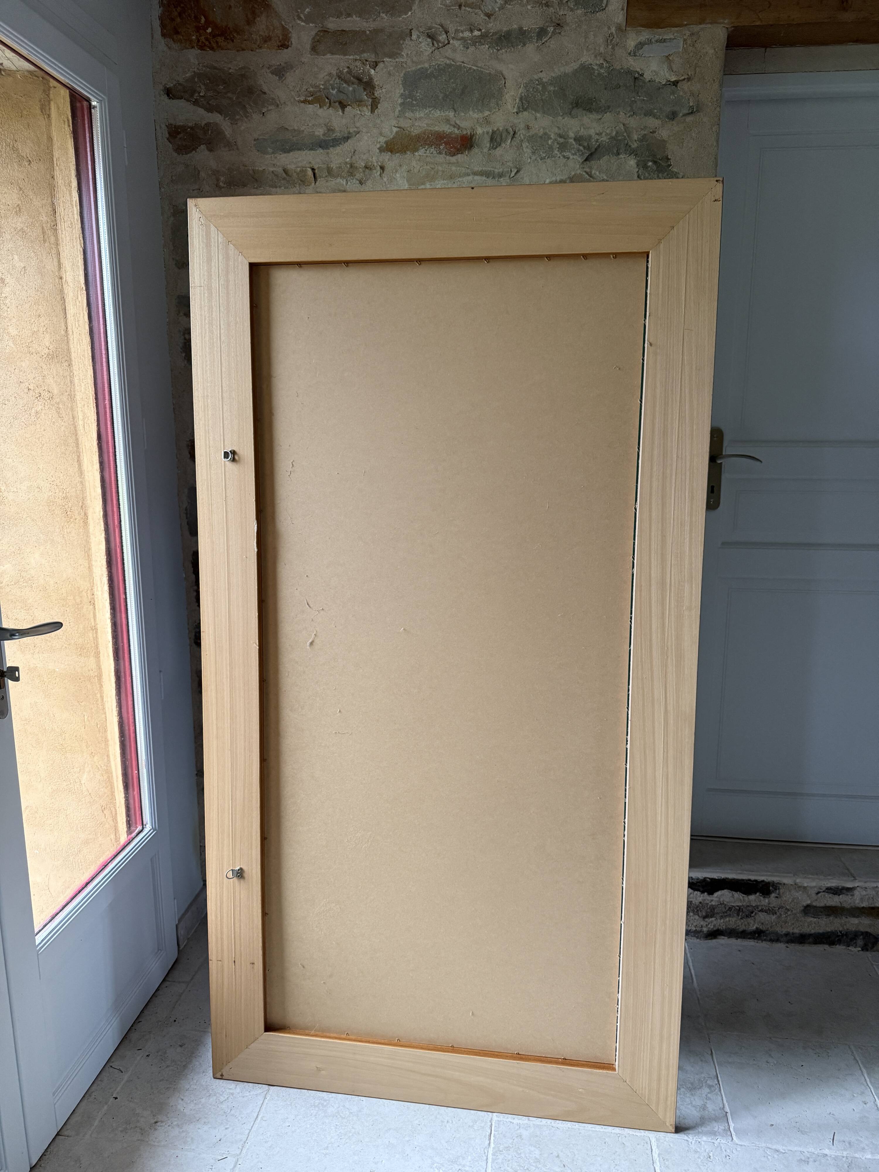 Large bevelled tabletop mirror in carved gilded wood.