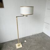 Floor lamp with articulated arm in brass-plated metal