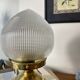 Antique globe table lamp in glass, Holophane type, and brass.