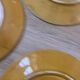 Four antique dessert plates in majolica with vine decoration.