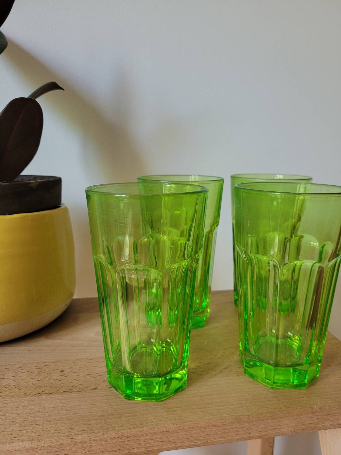 Four neon green lemonade glasses