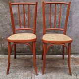 Pair of wooden and cane bistro chairs