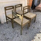 Set of 4 brown wooden dining chairs with straw seats, 1970s.