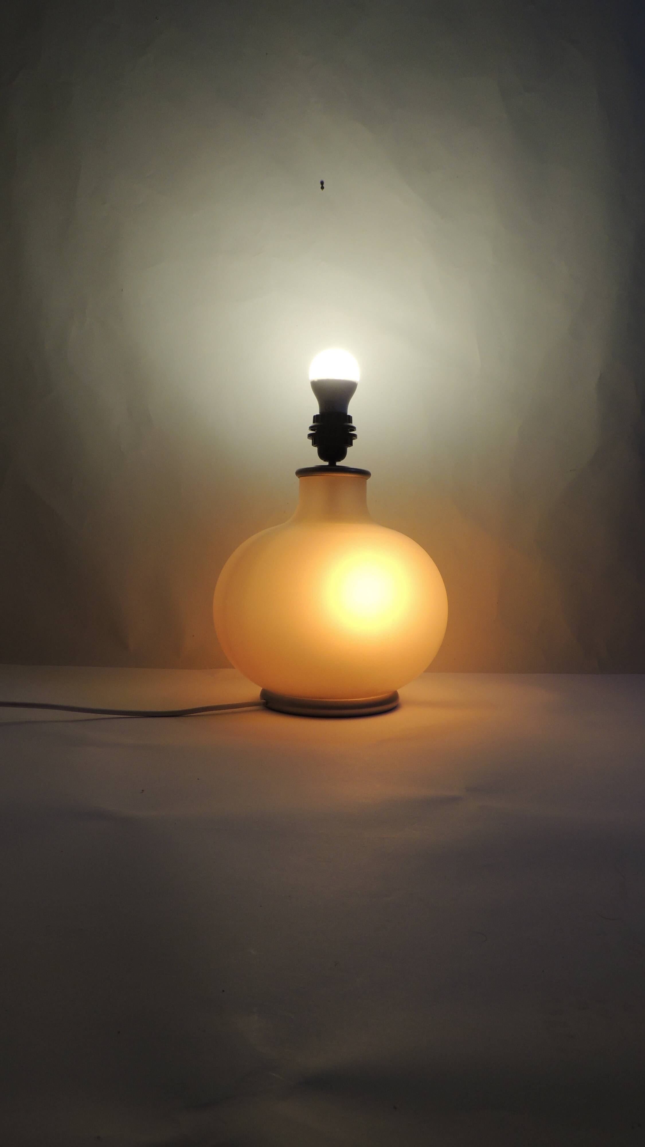 Vintage frosted glass lamp, round globe, elegant design, soft light.