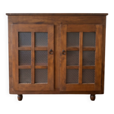 Small antique wooden sideboard with glass doors.