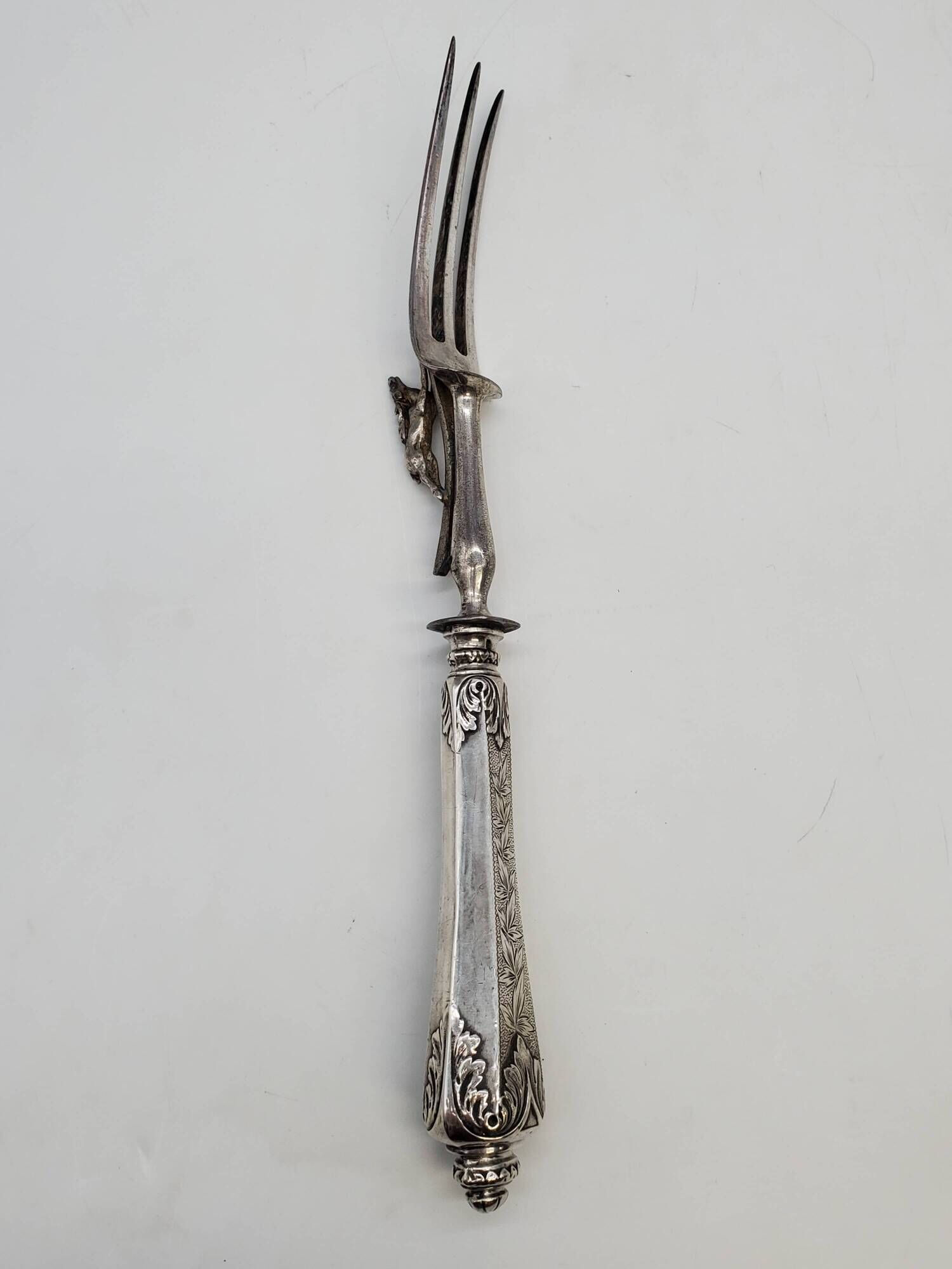 Set of serving forks and silver-plated leg of lamb fork.