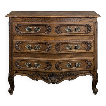 Neo-rustic commode richly carved with curves.
