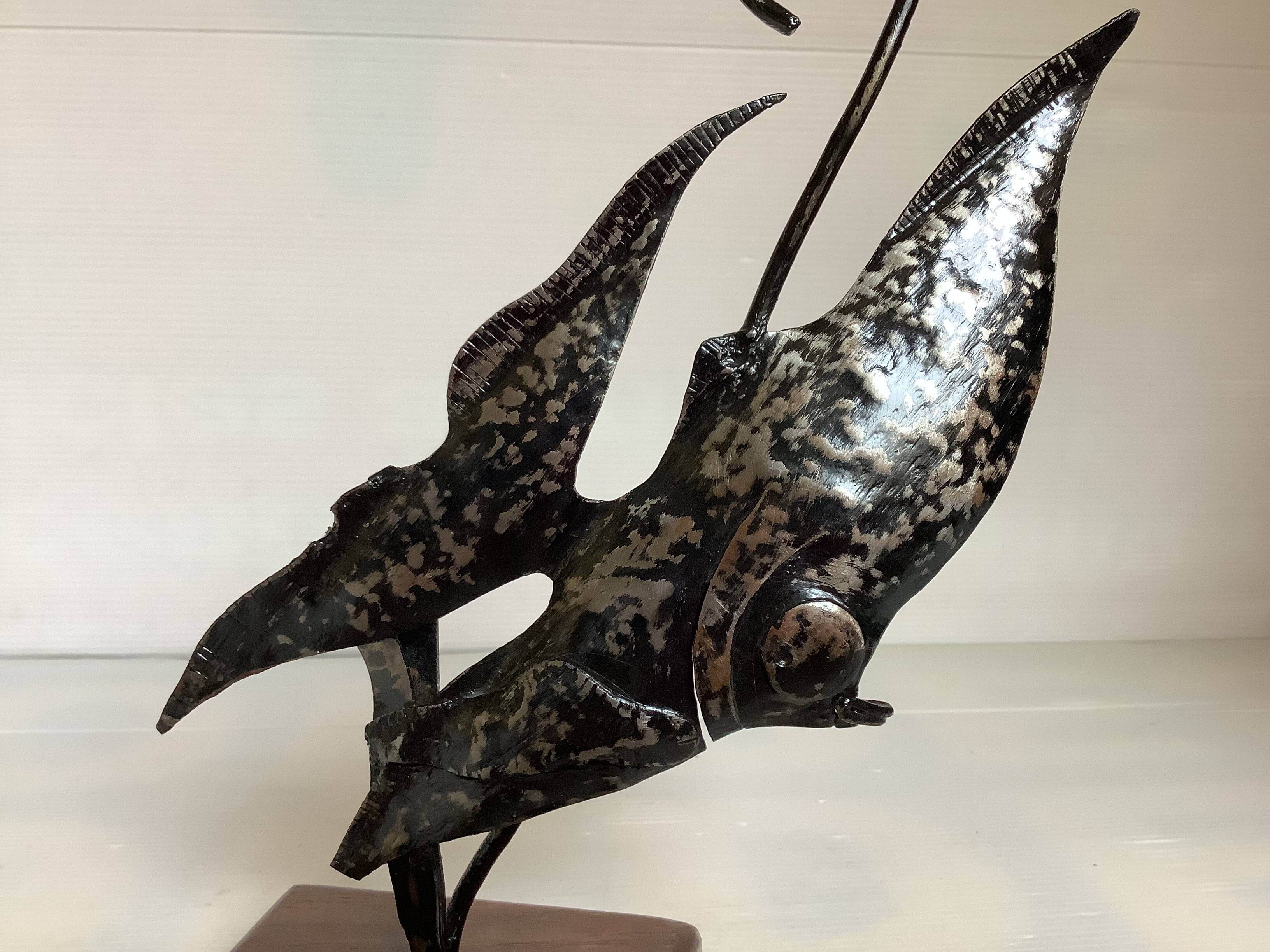 Small metal and wood fish statue