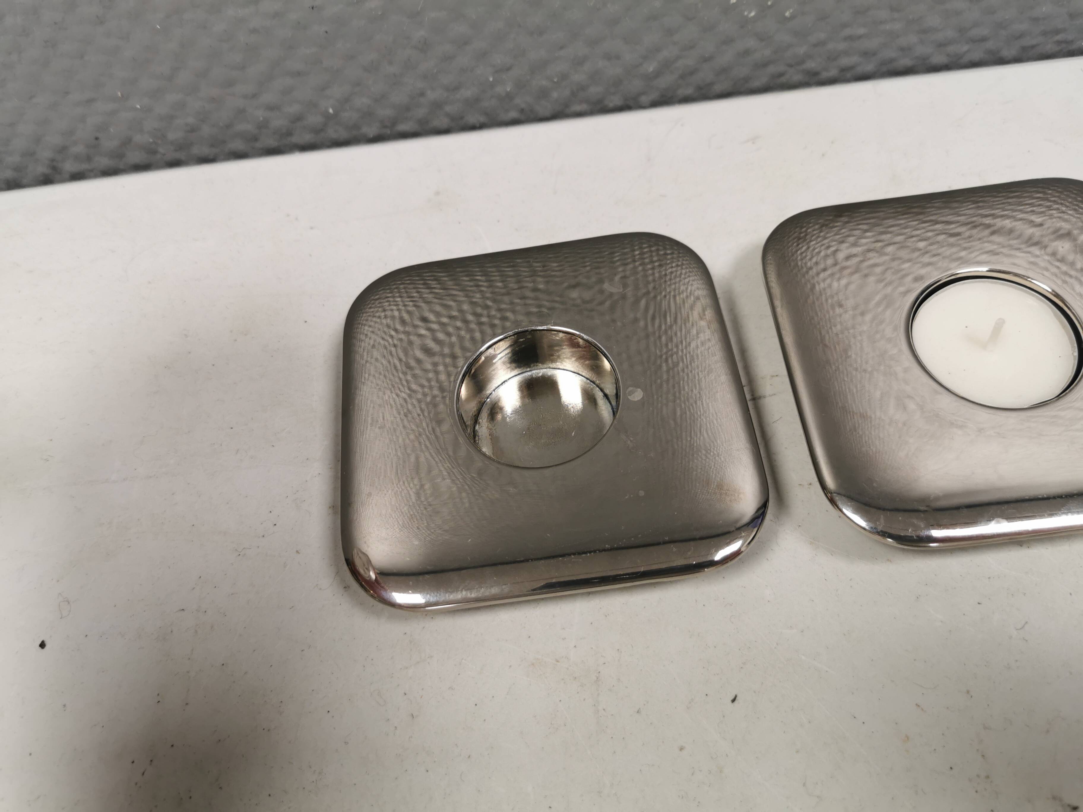 A set of classic Danish candlesticks in polished metal.