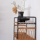 Woven rattan shelf and black metal
