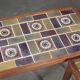 Pair of rosewood lamp tables, inlaid with coloured tiles