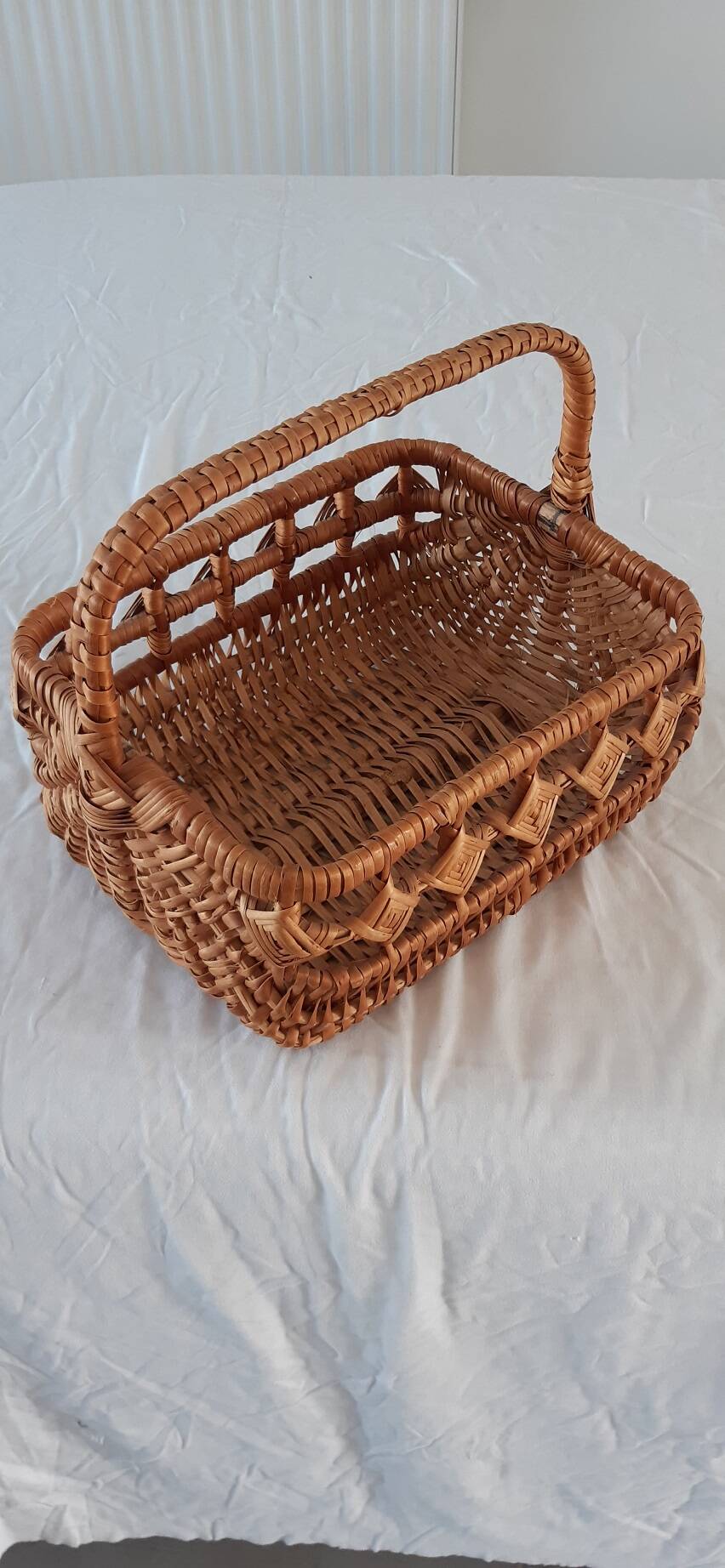 Old wicker basket with diamond-shaped decorations