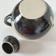 Vintage ceramic teapot with a flame design.