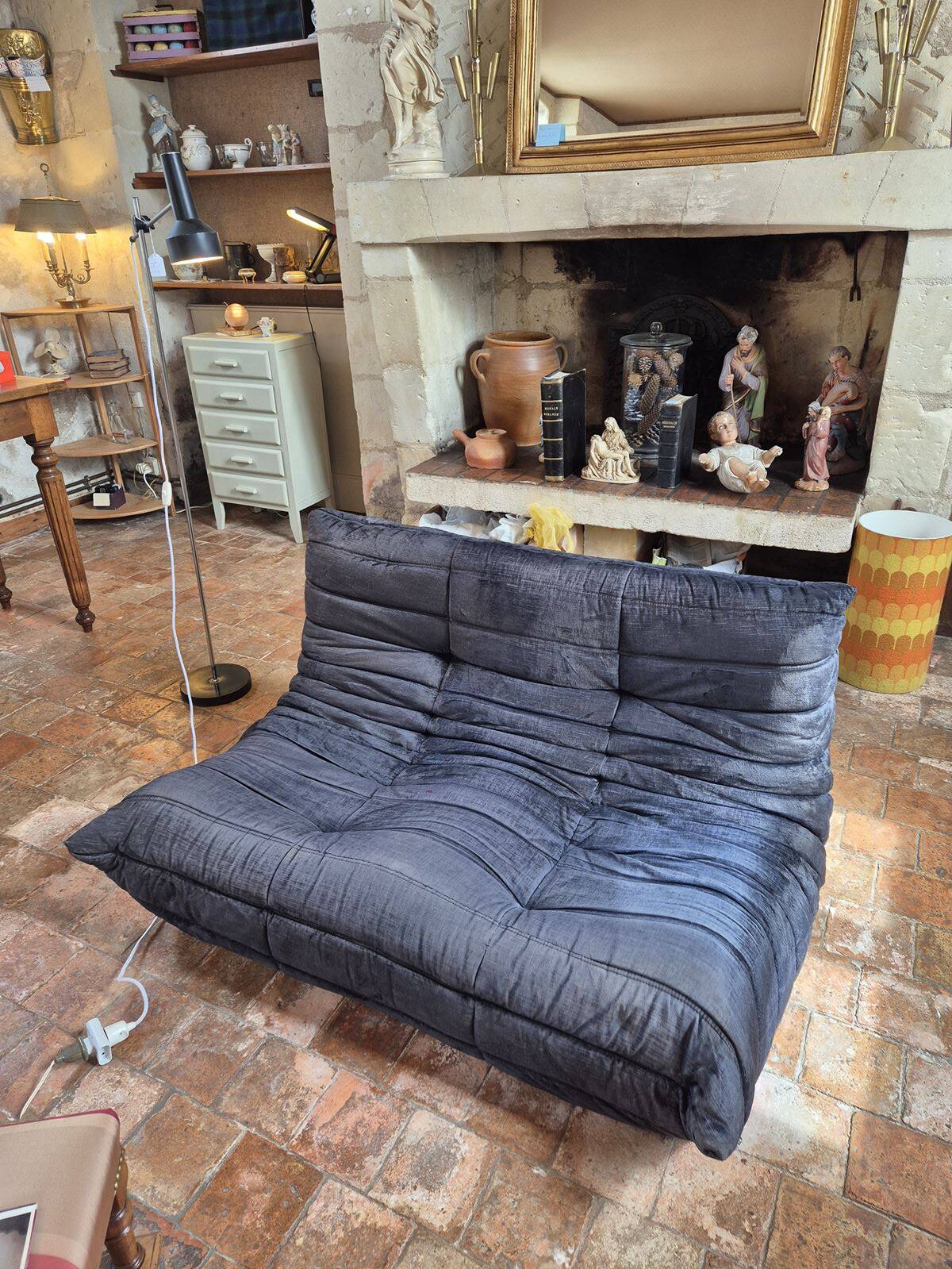 Togo sofa by Ligne Roset and its pouf from the 1970s.