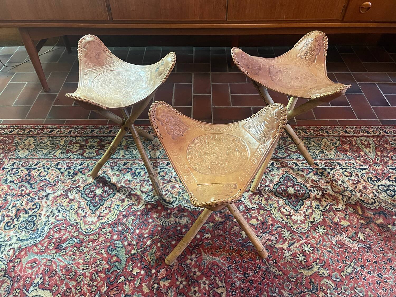 Vintage Mexican tripod stools in bamboo and leather.