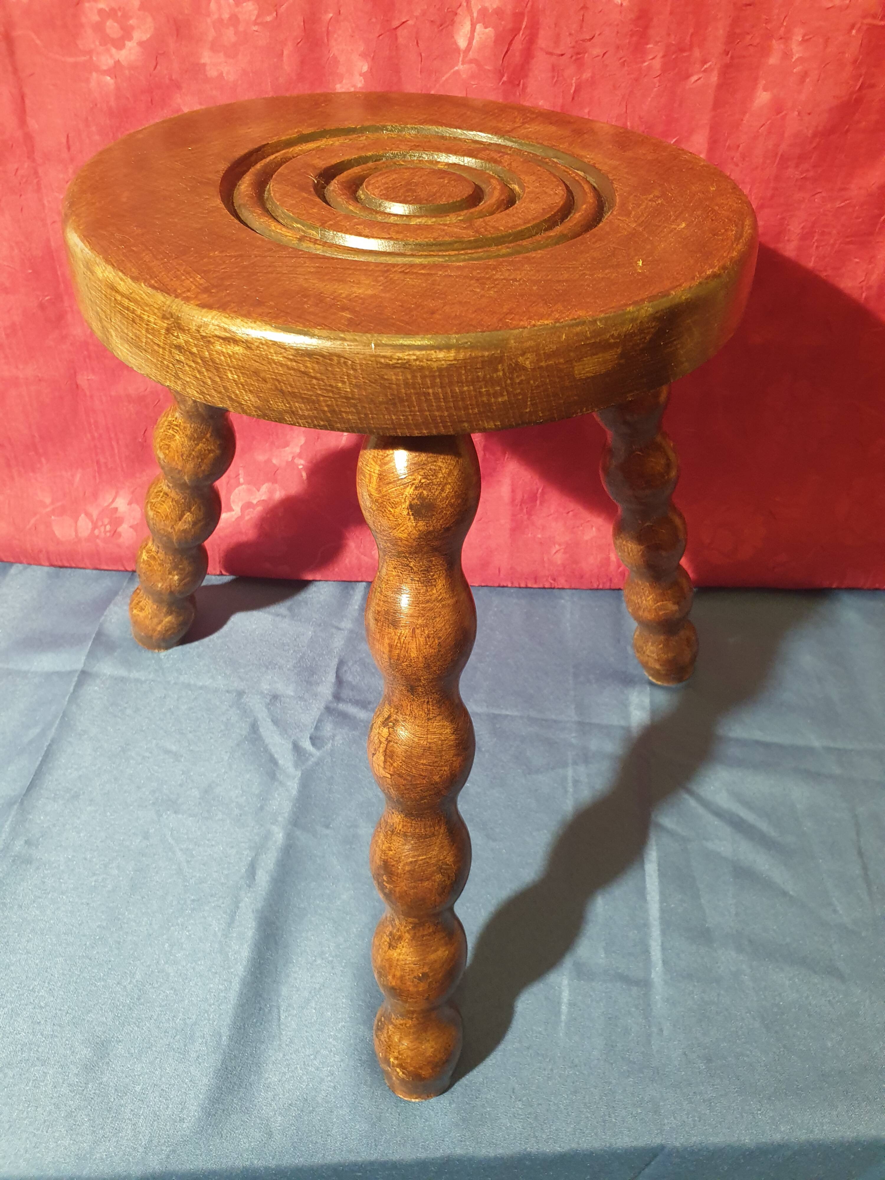 Wooden milking stool with twisted legs