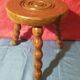 Wooden milking stool with twisted legs