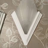 Pair of Art Deco wall sconces in plaster and pressed glass.