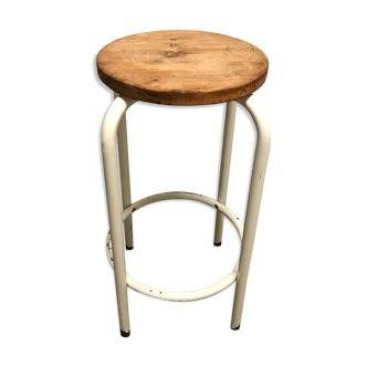 Vintage bar stool in white lace-up, round wooden seat rests circular feet