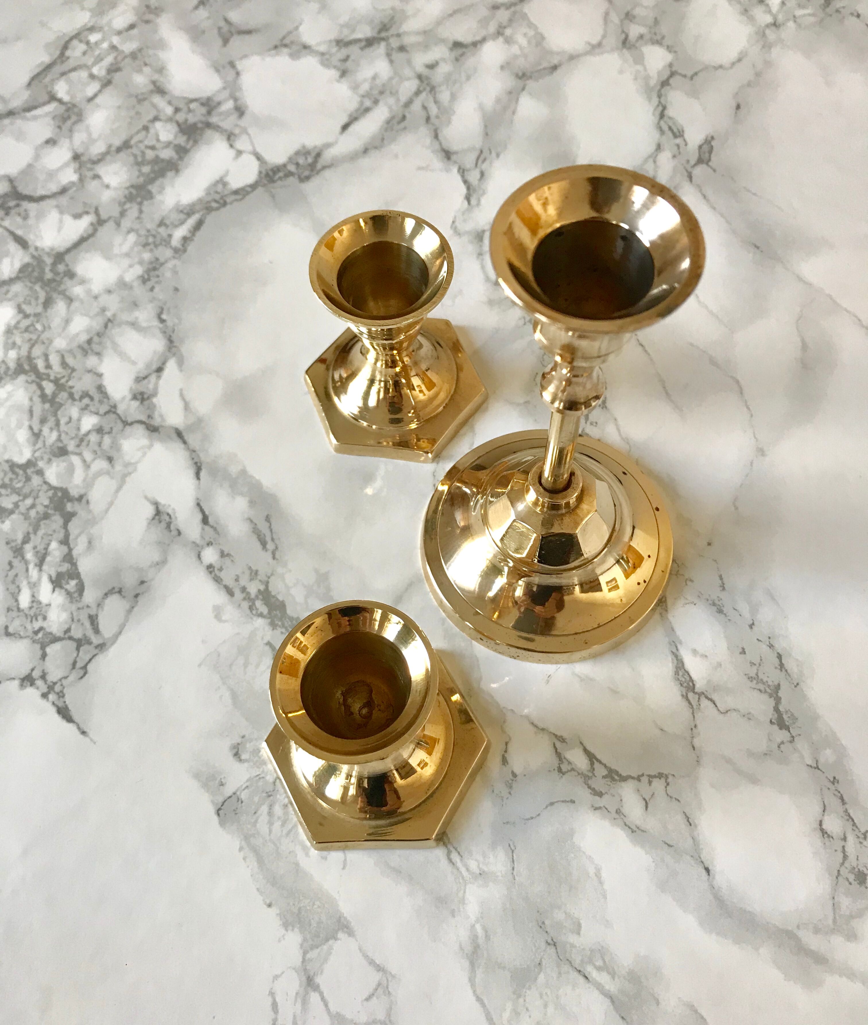 Set of three candlesticks in brass