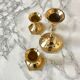 Set of three candlesticks in brass