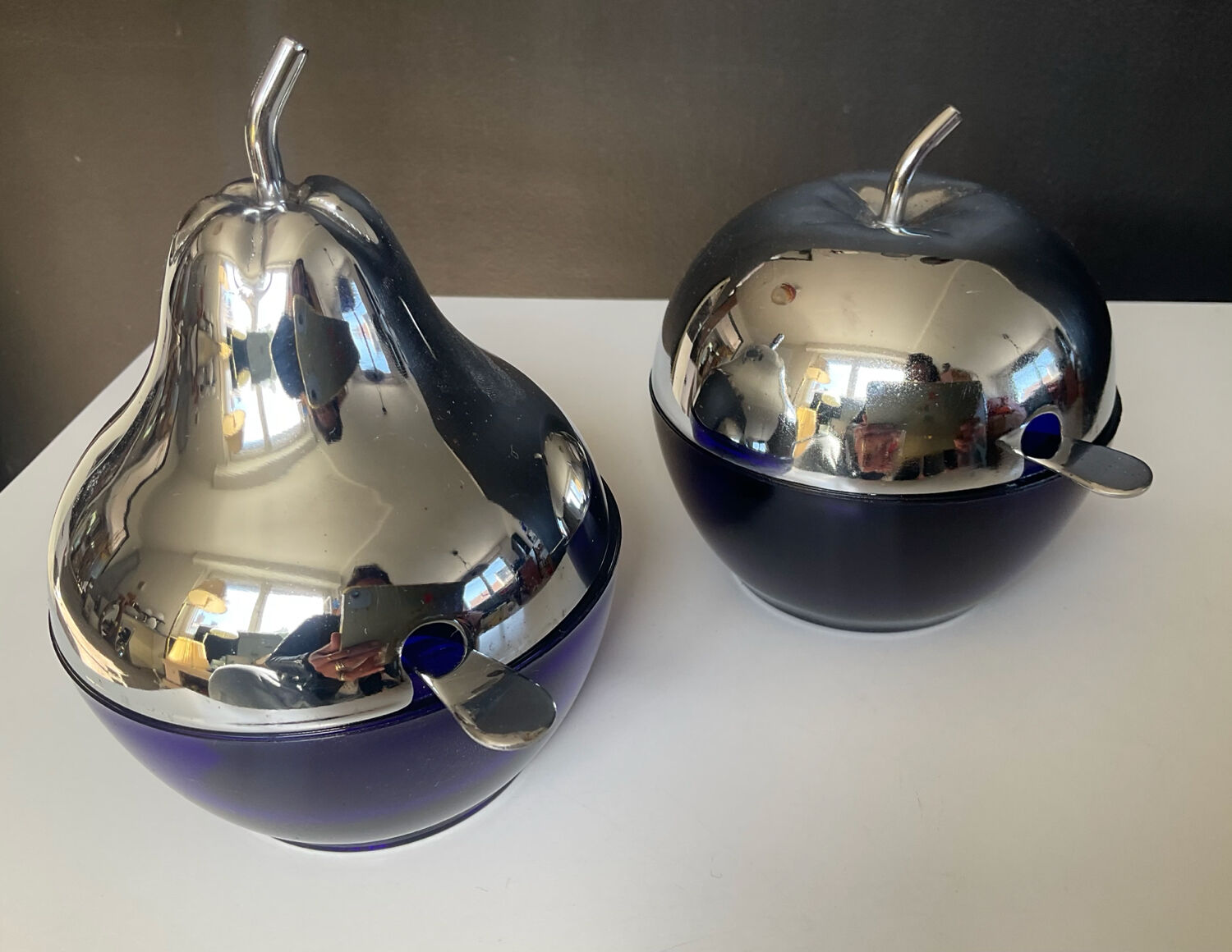 A pair of vintage cobalt glass and silver-plated sugar bowls.