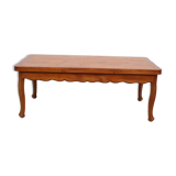 Large solid wood table with integrated extensions.