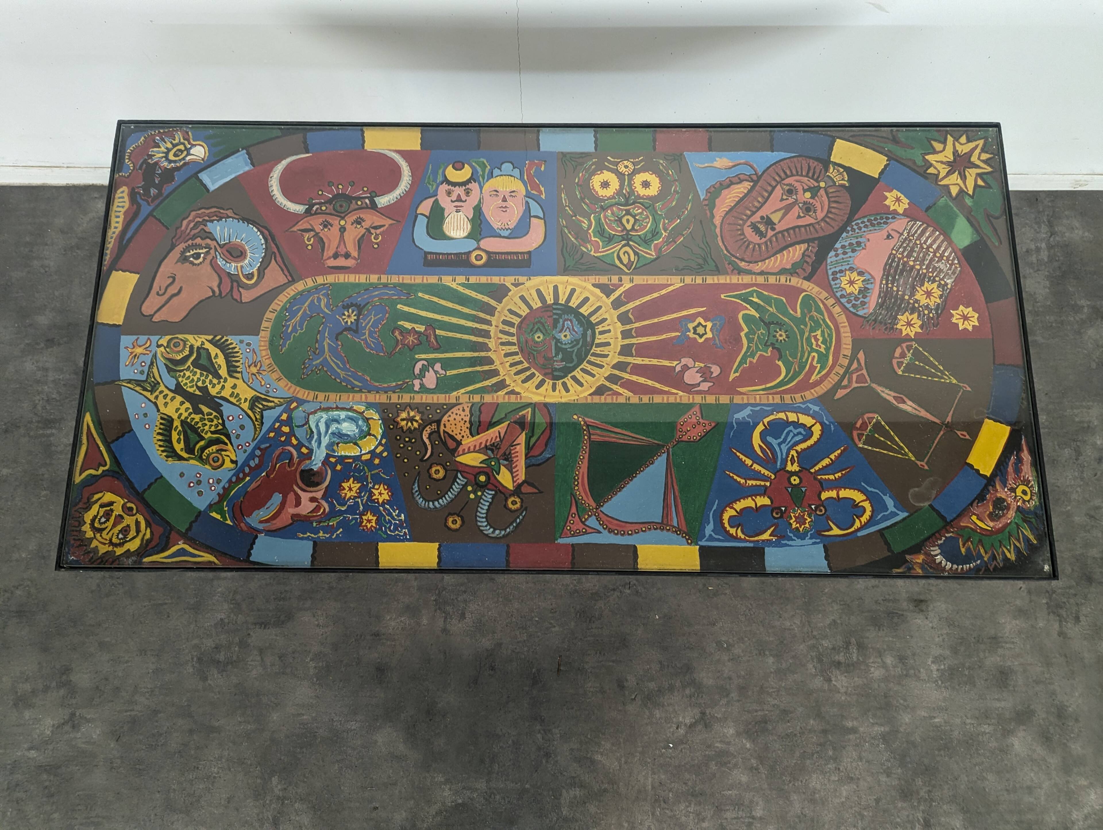 Chrome steel coffee table with zodiac signs decoration.