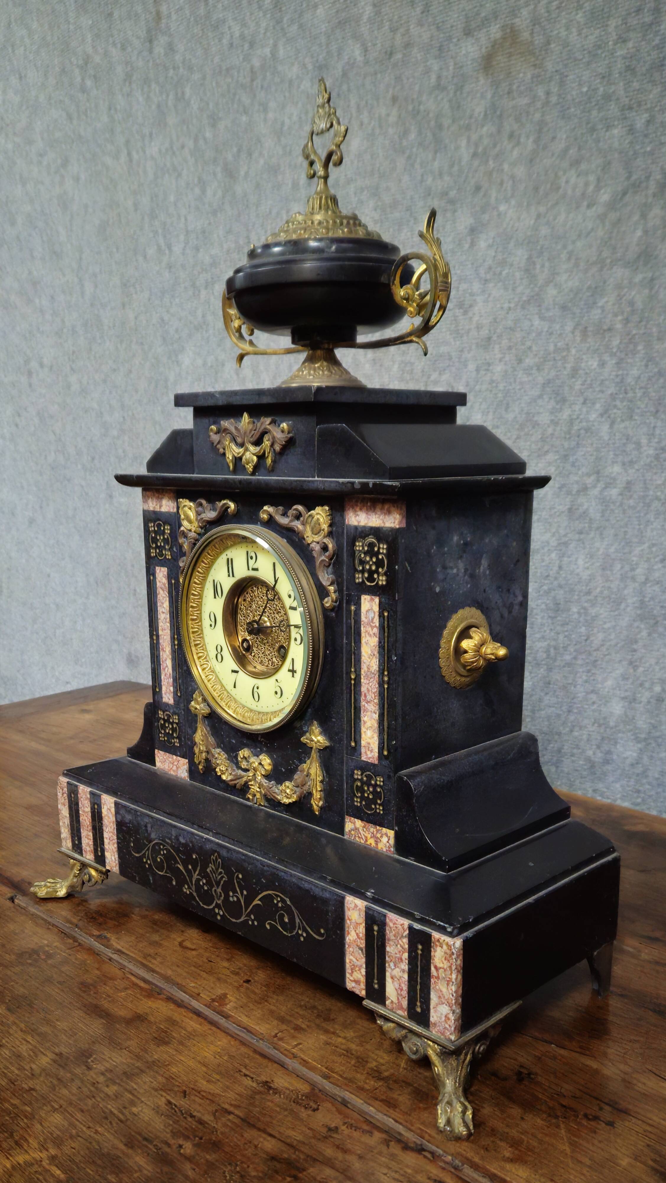 Large notary clock in black marble and gilded bronze.