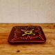 Vintage ceramic trivet with a 70s pattern.