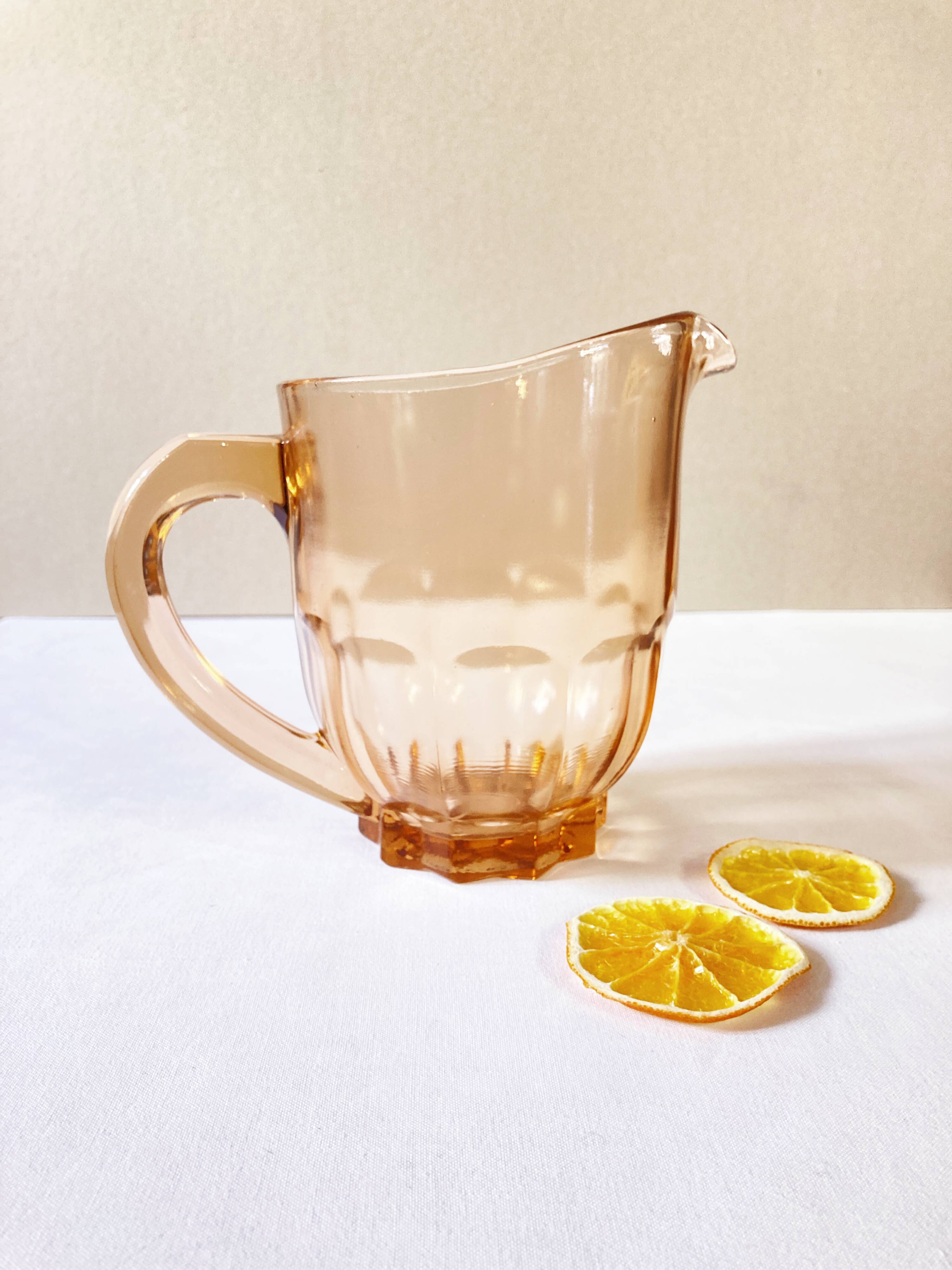 Pitcher and 6 water glasses in pink glass