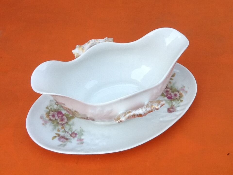 Sauce boat on dormant white porcelain, floral decoration