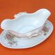 Sauce boat on dormant white porcelain, floral decoration