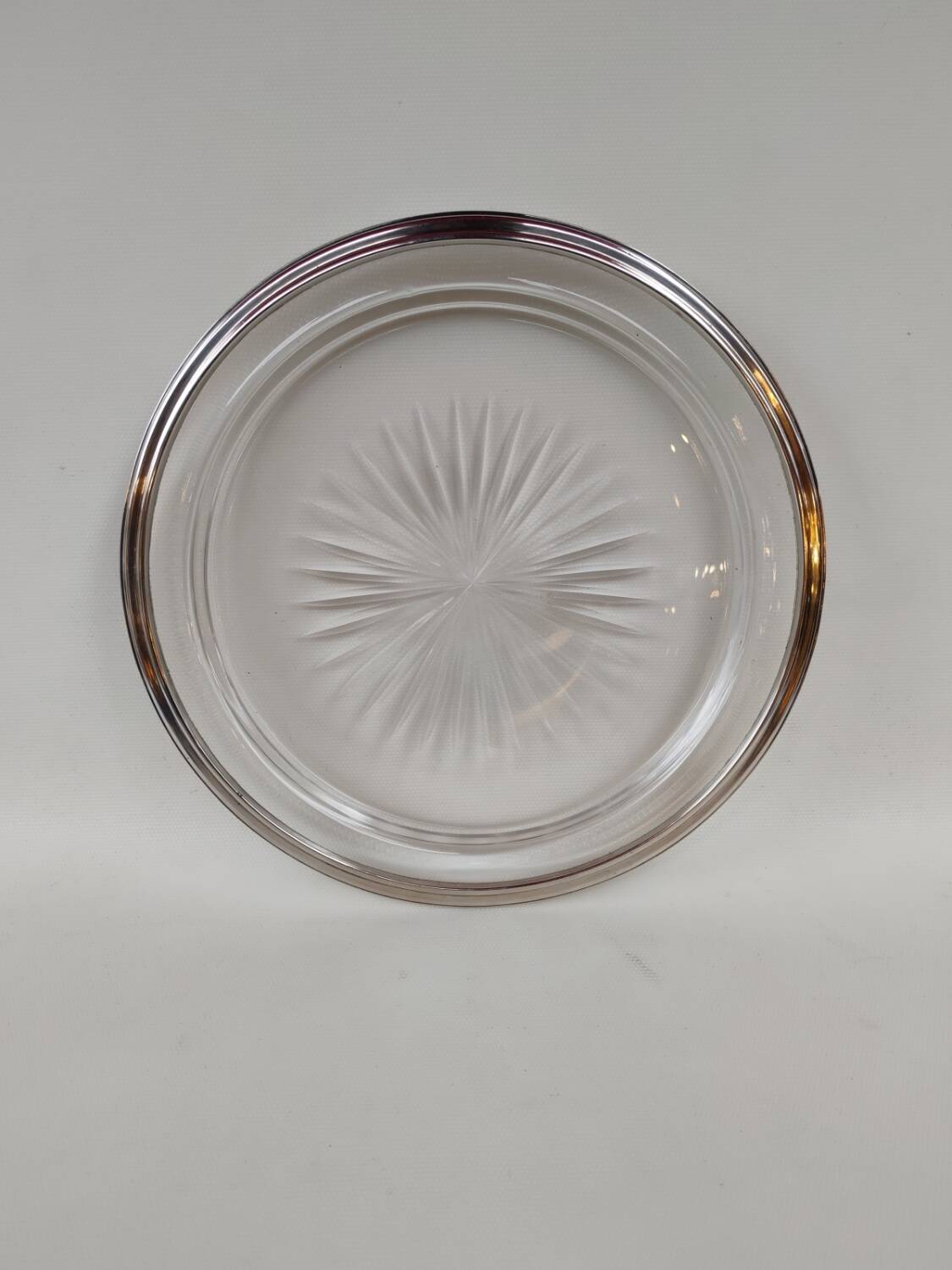 Cut crystal tray and solid silver rim.