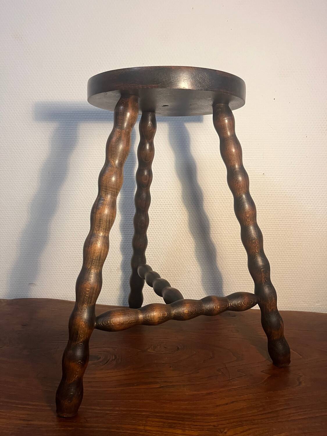 Round tripod stool with turned wooden legs