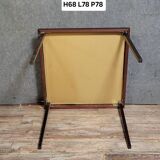 a wooden Bridge game table resting on four thin, straight legs