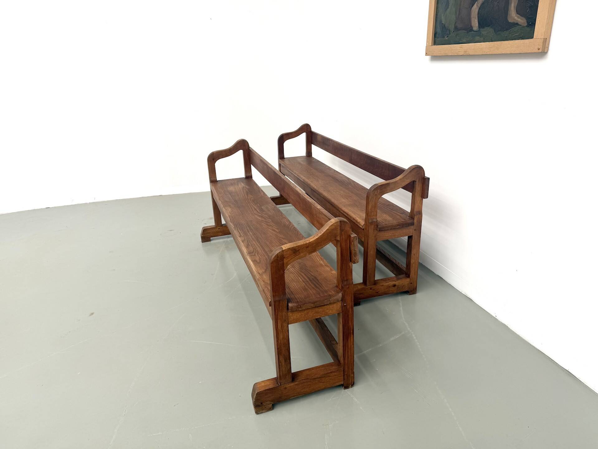 Pair of communal benches in solid oak, 1950s.
