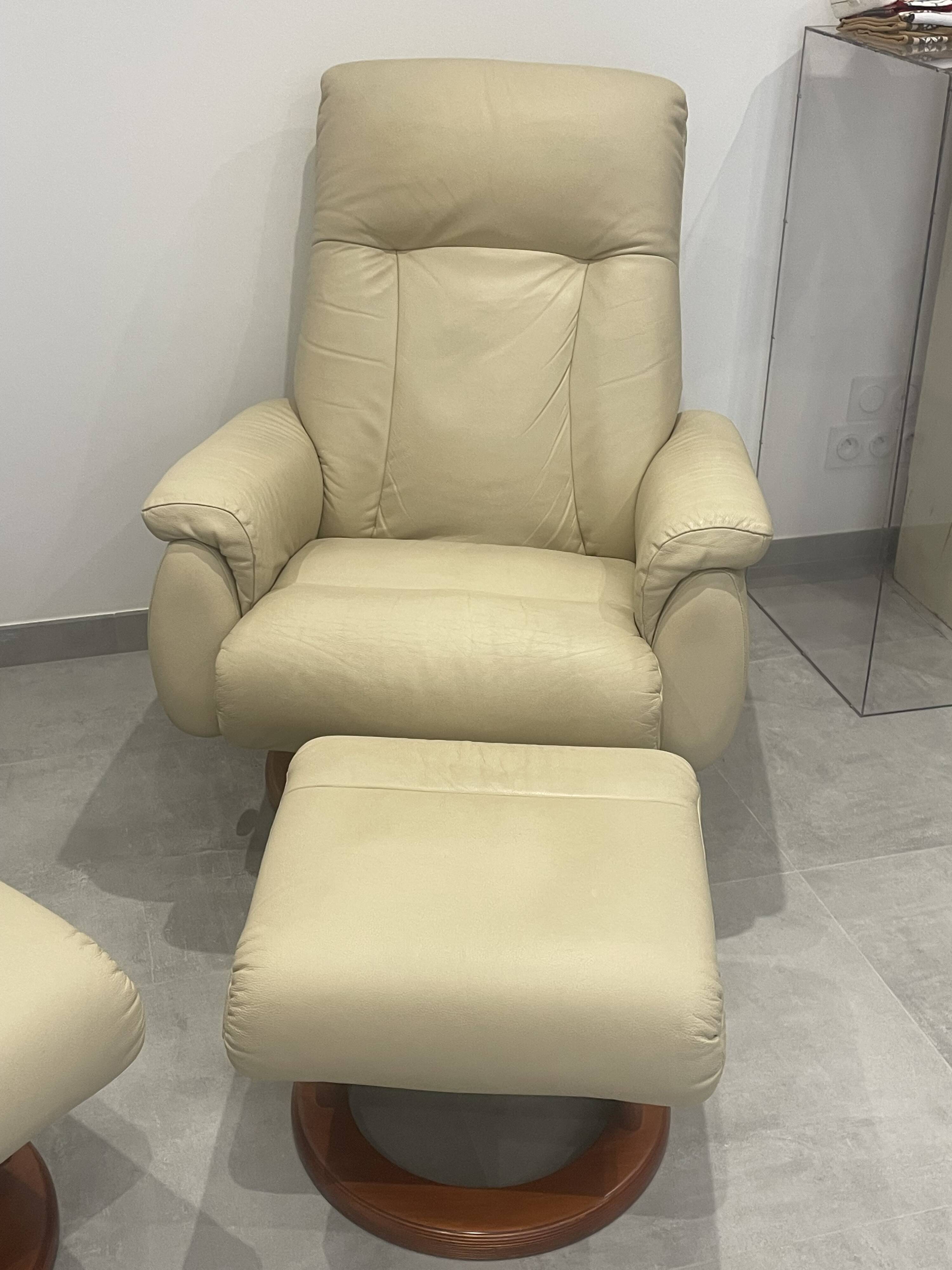 Pair of vintage leather armchairs with ottoman