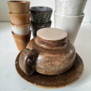 Set of 8 stoneware cups and a mug, shades of beige.