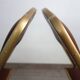 2 golden metal chairs with faux leather in the 60s/70s Opera style.