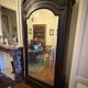 Black wardrobe with a mirrored door in ebony finish.