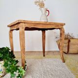 Antique coffee table with curved legs.