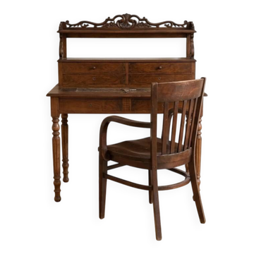 Old wooden tiered desk and its matching chair.