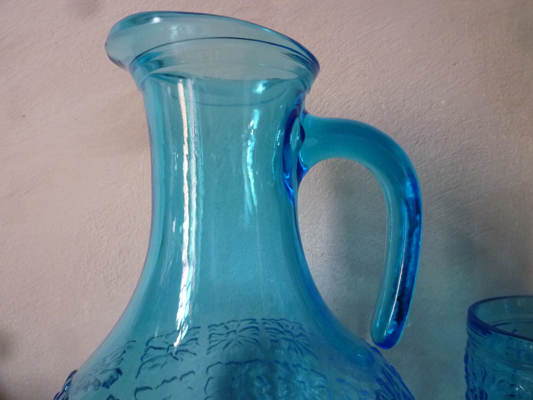 Blue glass carafe and two glasses