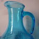 Blue glass carafe and two glasses