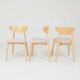 Set of 6 pale pink dining chairs in natural wood.
