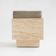 Cubic travertine stool with velvet cushion
