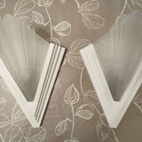 Pair of Art Deco wall sconces in plaster and pressed glass.