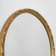 Oval mirror with gilded wood from the 1960s.