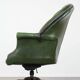Large Chesterfield office armchair in green cowhide, in English style, on wheels.